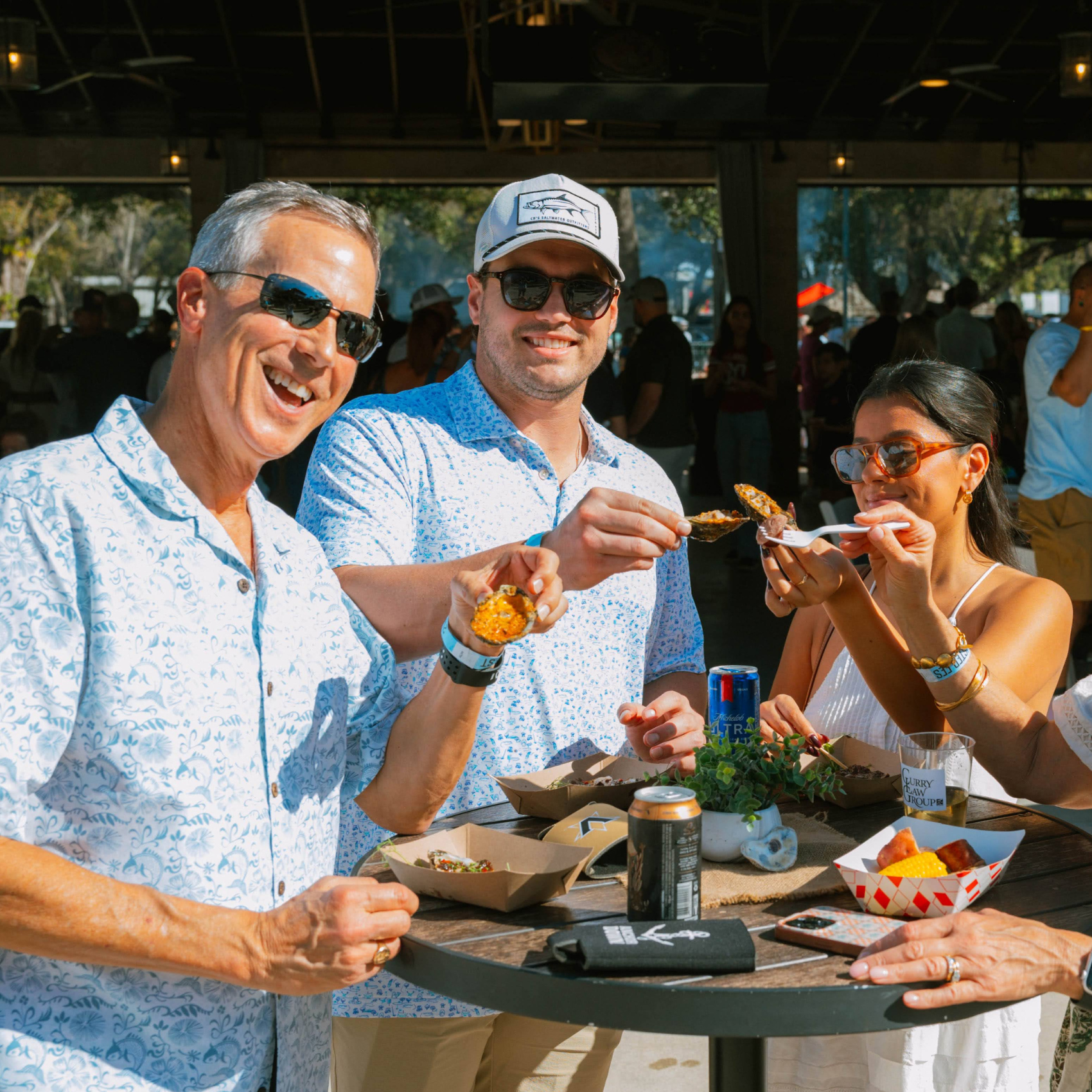 People eating oysters at Tampa Oyster Fest